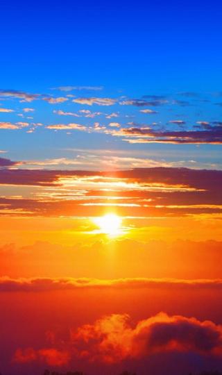 好看的壮观的蓝天中的橙红日落背景图
